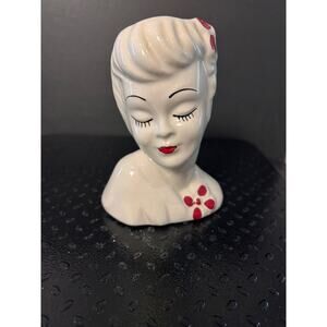 white ceramic lady head vase identified as a vintage "Glamour Girl" planter